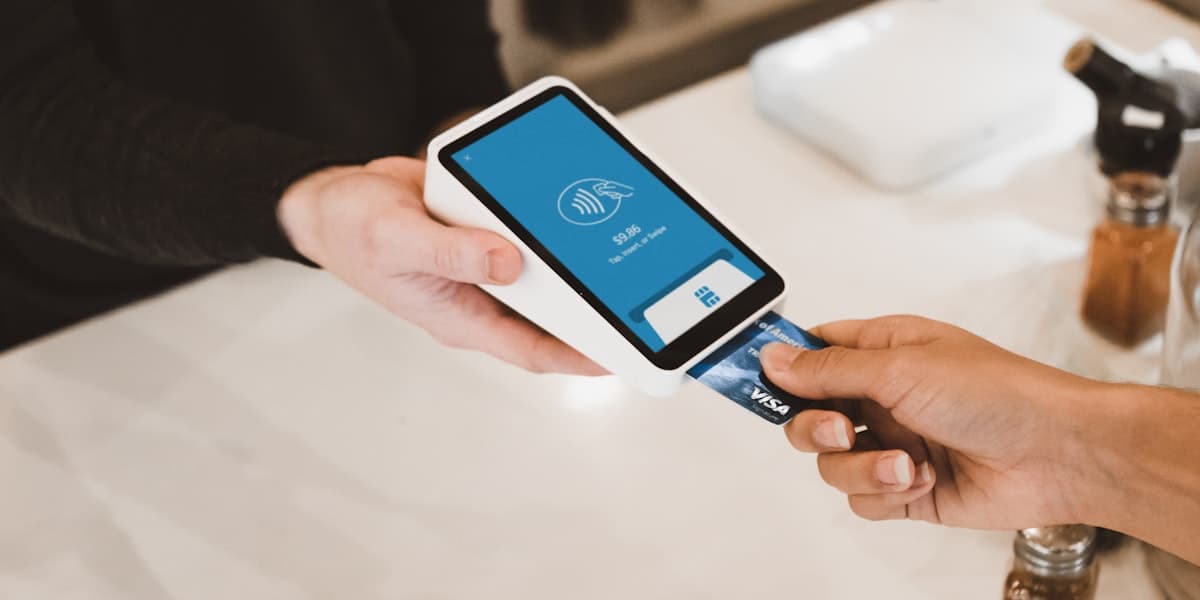 A contactless card payment being taken on a handheld terminal.