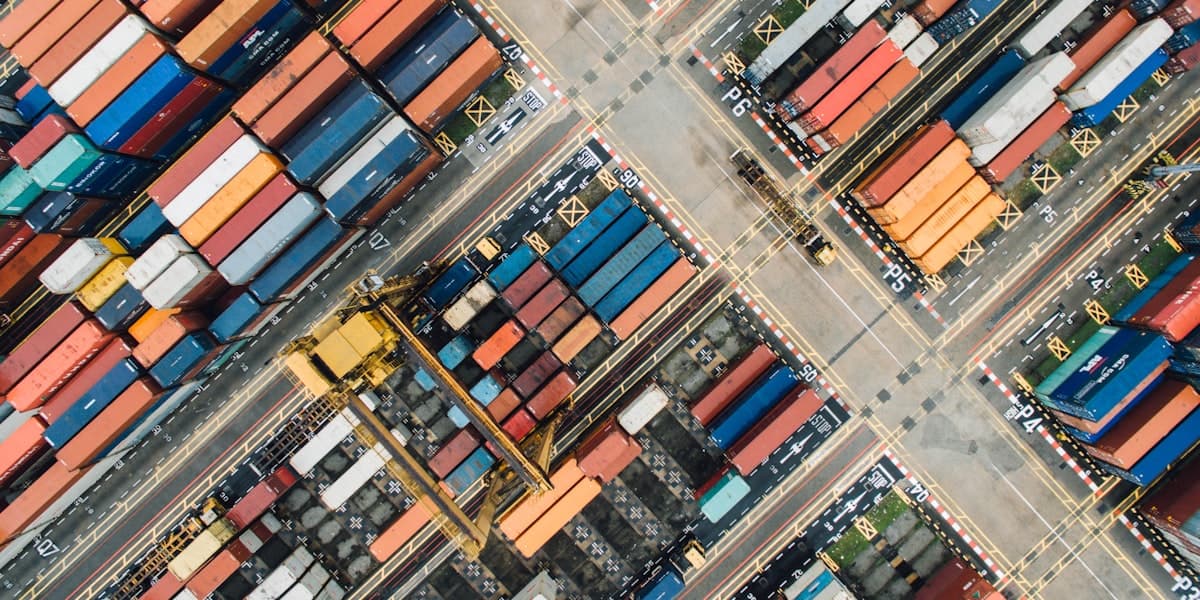 Shipping containers stacked in a freight yard, seen from directly above.
