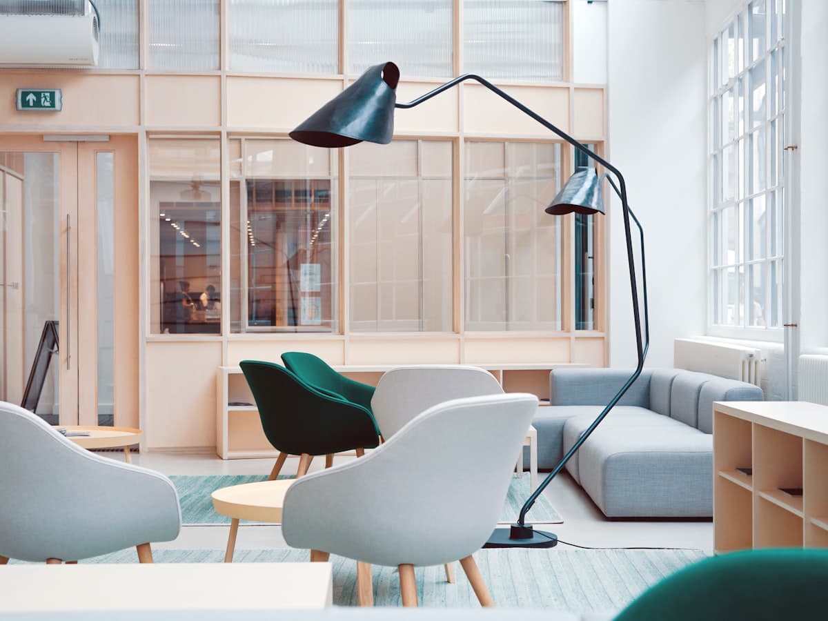 A quiet, light-filled workspace with armchairs and a low table.